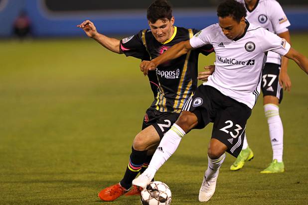 Las Vegas Lights' Matt Thomas (21) of Las Vegas and Tacoma Defiance's Henry Wingo (23) fight for the ball during a game at Cashman Field Saturday, April 13, 2019. The Lights shut out the Defiance 5-0.