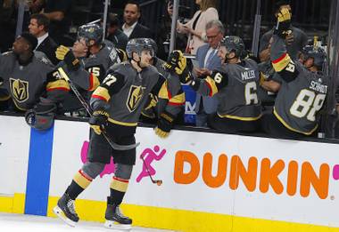 Vegas Golden Knights defenseman Shea Theodore (27) is congratulated after scoring against the San Jose Sharks during the first period of Game 4 of a first-round NHL hockey playoff series Tuesday, April 16, 2019, in Las Vegas.