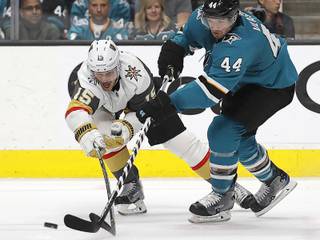 Vegas Golden Knights' Jon Merrill, left, and San Jose Sharks' Marc-Edouard Vlasic (44) fight for the puck during the second period of Game 5 of an NHL hockey first-round playoff series Thursday, April 18, 2019, in San Jose, Calif.