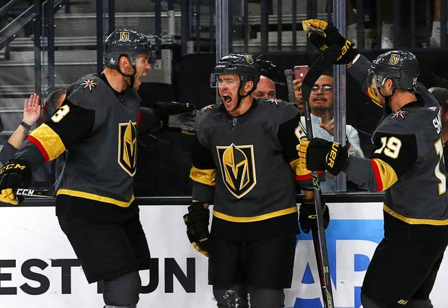 Vegas Golden Knights center Jonathan Marchessault, center, (81)celebrates with Brayden McNabb, left, (3) and Reilly Smith (19) after scoring on the San Jose Sharks in the second period during Game 6 of an NHL hockey first-round playoff series at T-Mobile Arena Sunday, April 21, 2019. 