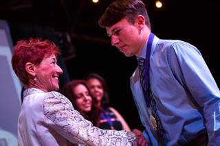 Beverly Rogers of the Rogers Foundation shakes hands with a Clark County high school senior during a scholarship presentation at the Industrial Event Space Saturday April 27, 2019.