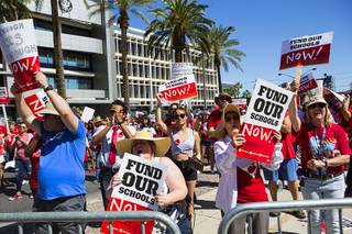 Attendees hold up signs during a rally held in support of more education funding by the Clark County Education Association at the Lloyd D. George U.S. Court House in Las Vegas on Saturday, April 27, 2019.