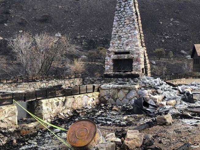 This October 2018 photo provided by the Elko Lion's Club shows a fireplace and chimney, the only things remaining from the historic Warner Whipple Lodge in Lamoille Canyon that was destroyed on Sept. 30, 2018, in an explosive wildfire that leveled most of an 80-year-old youth camp in the Ruby Mountains southeast of Elko. Volunteers plan to return to the Lion's Club's Camp Lamoille in June to begin a $1 million rebuilding effort.