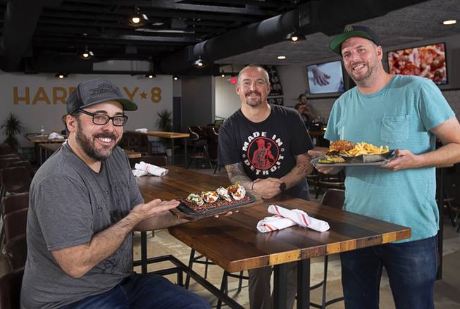 Owners Bryant Jane, left, and Lyle Cervenka, right, with consulting chef Johnny Church, center, at the Hardway 8, 46 S. Water St., in downtown Henderson, May 14, 2019. Food pictured are: Buffalo Fried Oysters, left, and the MusBURGER,