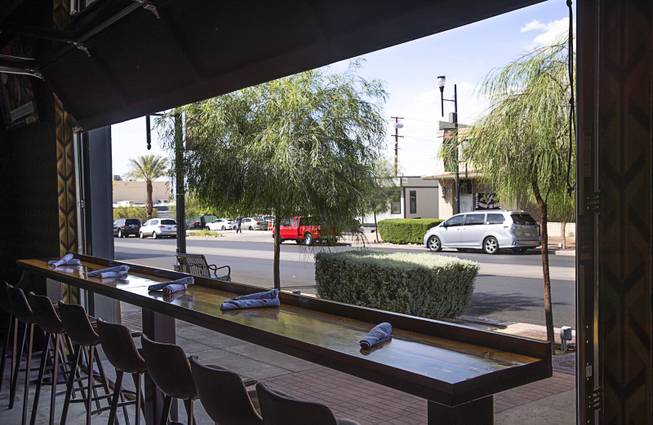 A table faces Water Street at the Hardway 8 in downtown Henderson, May 14, 2019.