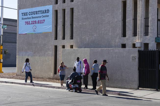 People gather outside of the Courtyard Homeless Resource Center near downtown Las Vegas, Friday, May 17, 2019. The facility provides a safe place for the homeless to sleep at night. 