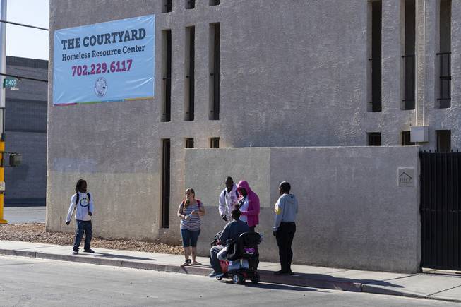 People gather outside of The Courtyard Homeless Resource Center downtown Friday, May 17, 2019.