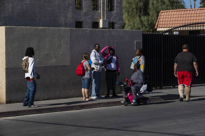 People gather outside of The Courtyard Homeless Resource Center downtown Friday, May 17, 2019.