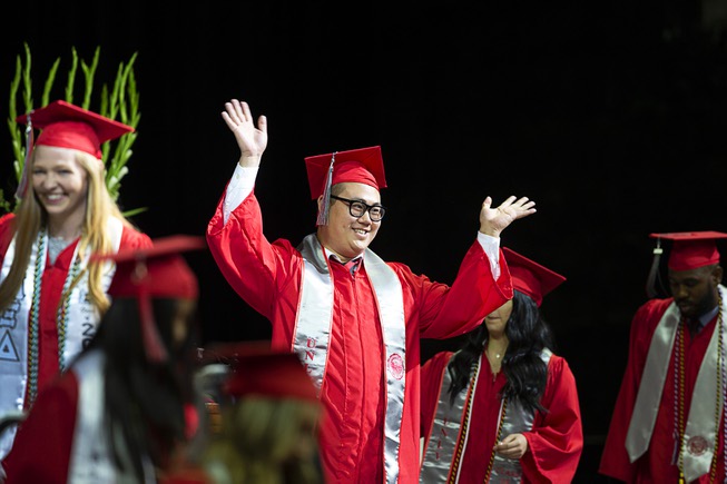 A graduate waves from the stage during UNLV commencement at ...