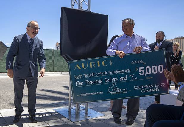 Myron Martin, left, president and CEO of the Smith Center for the Performing Arts, accepts a $5,000 donation from the Southern Land Company (SLC) during a groundbreaking ceremony for Auric, a luxury, mid-rise apartment complex by SLC, at Symphony Park in downtown Las Vegas, May 21, 2019. The complex will be built on six acres of vacant land north of the Smith Center for the Performing Arts.