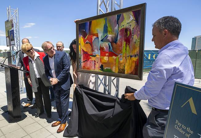 Las Vegas Mayor Carolyn Goodman and Tim Downey, CEO, Southern Land Company (SLC), lean forward as artwork by Las Vegas artist Niki Sands is unveiled during a groundbreaking ceremony for Auric, a luxury, mid-rise apartment complex by Southern Land Company (SLC), at Symphony Park in downtown Las Vegas, May 21, 2019. The complex will be built on six acres of vacant land north of the Smith Center for the Performing Arts.