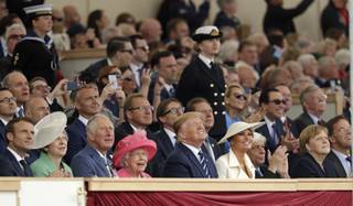 French President Emmanuel Macron, British Prime Minister Theresa May, Britain's Prince Charles, Queen Elizabeth II, President Donald Trump, first lady Melania Trump, Greek President Prokopis Pavlopoulos, German Chancellor Angela Merkel and Dutch PM Mark Rutte, front row from left, watch a fly past at the end of an event to mark the 75th anniversary of D-Day in Portsmouth, England Wednesday, June 5, 2019. World leaders including U.S. President Donald Trump are gathering Wednesday on the south coast of England to mark the 75th anniversary of the D-Day landings. (AP Photo/Matt Dunham)