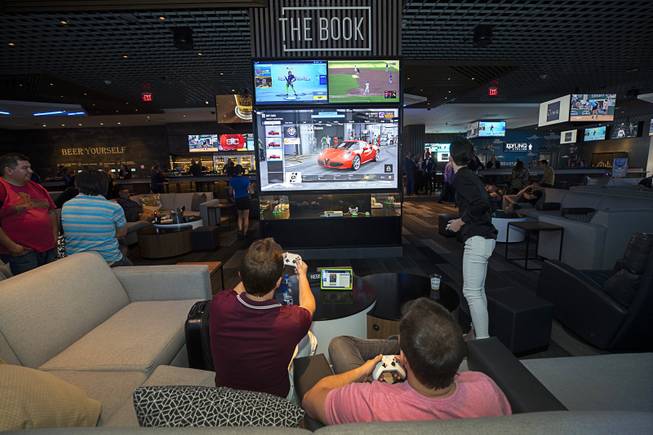 Patrons play a computer game in The Book during the ...
