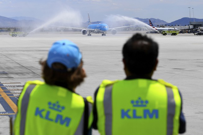 KLM Royal Dutch Airlines Flight 635 passes under a ceremonial ...