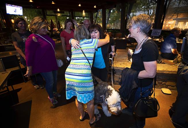City Council Ward 2 candidate Hilarie Grey, center, gets hugs from supporters at her election watch party at Lazy Dogs in Downtown Summerlin Tuesday, June 11, 2019. Grey came in second place behind Victoria Seaman. 