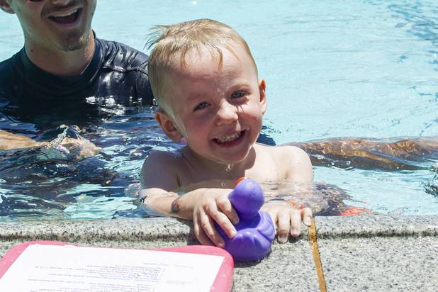 Odin Therien, 3, swims to the edge of the pool for the duck during the World's Largest Swim Lesson event at the Boulder City Swimming Pool Thursday, June 20, 2019.  The World's Largest Swim Lesson is a world wide event to promote awareness and safety when swimming.
