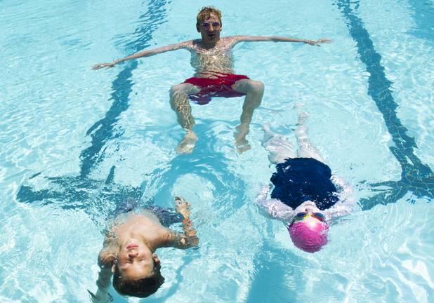 A lifeguard teaches participants to float on their back during the World's Largest Swim Lesson event at the Boulder City Swimming Pool Thursday, June 20, 2019.  The World's Largest Swim Lesson is a world wide event to promote awareness and safety when swimming.