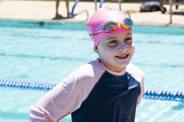Hannah Tibbs, 9, smiles following a swim lesson during the World's Largest Swim Lesson event at the Boulder City Swimming Pool Thursday, June 20, 2019.  The World's Largest Swim Lesson is a world wide event to promote awareness and safety when swimming.