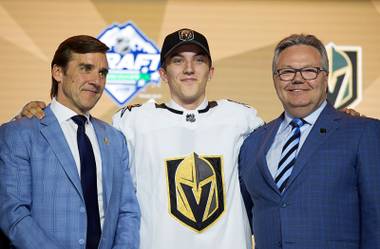 Vegas Golden Knights pick Peyton Krebs, center, poses during the first round of the NHL hockey draft at Rogers Arena in Vancouver, British Columbia, Friday, June, 21, 2019.