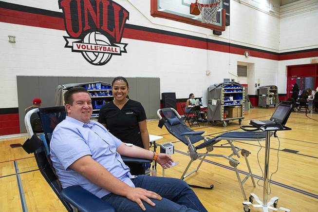 Andrew Bennett, public information officer for Nevada's Office of Traffic Safety, donates blood with Vitalant phlebotomist Shae Stanley during the 10th Annual Lindsay Bennett Memorial Blood Drive at UNLV Saturday, June 22, 2019. Bennett's sister Lindsay Bennett, a UNLV Rebel Girl, was killed by a drunk driver in 2009.