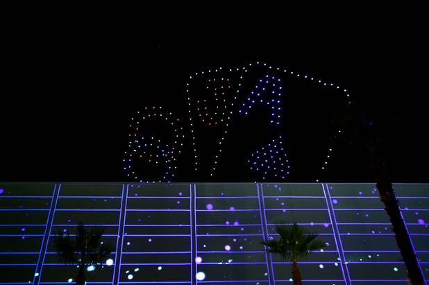Flying drones create a blackjack hand during an event announcing ...