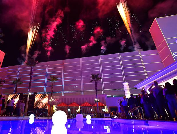 Flying drones light up the word 