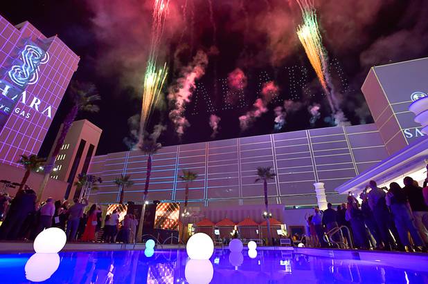 Flying drones light up the word 