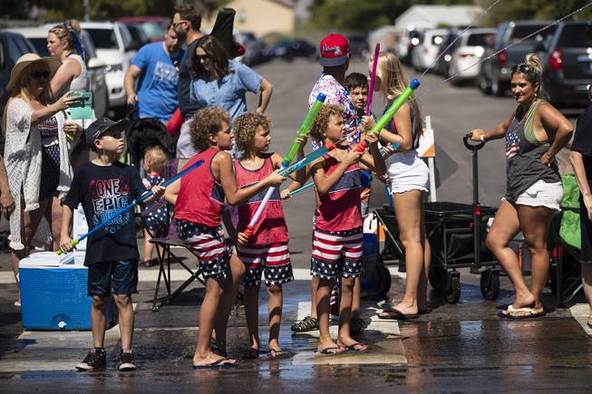 Children spray water guns during the 71st Annual Boulder City Damboree on Thursday, July 4, 2019.