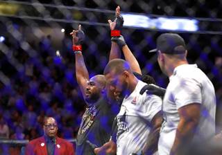 UFC light heavyweight champion Jon Jones, left, is announced as the winner over Thiago Santos of Brazil during UFC 239 at T-Mobile Arena Saturday, July 6, 2019. Jones retained his title by split decision.