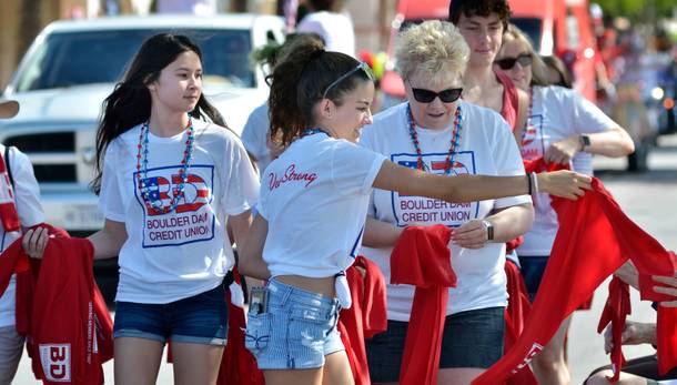 A contingent from the Boulder Dam Credit Union hands out cooling towels during the 71st Annual Boulder City Damboree Celebration in Boulder City on Thursday, July 4, 2019.