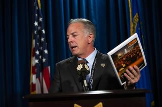 Clark County Sheriff Joe Lombardo holds up a copy of the 1 October After-Action Review report during a press conference at the Las Vegas Metropolitan Police Headquarters on Wednesday, July 10, 2019.