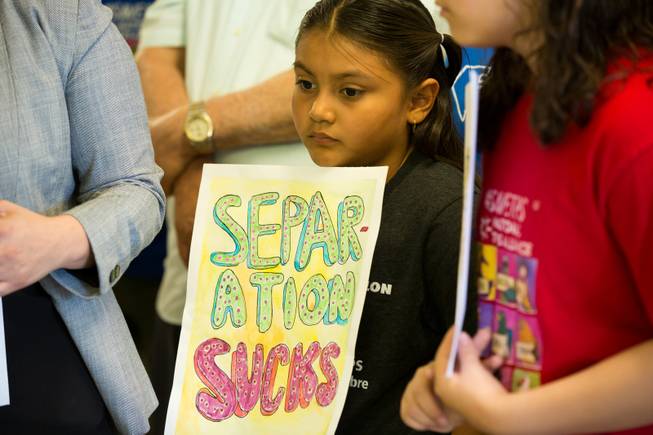 A little girl holds a sign that reads "separation sucks" during a press conference at the Las Vegas Workers Center to give an update on the Central American Minors humanitarian parole program, a program created back in 2014 that would allow at risk children in Central America to reunite with their parents who resided in the US legally. Monday July 15, 2019.