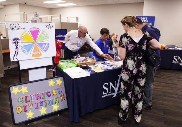Attendees visit an informational booth following the State of the Health District address at the Southern Nevada Health District office building Thursday, July 18, 2019.