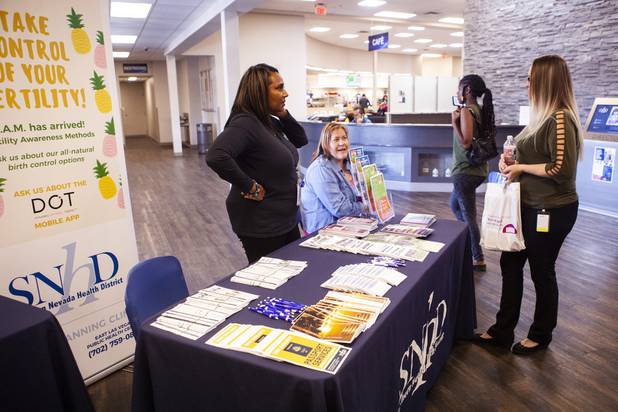An attendee visits an informational booth following the State of the Health District address at the Southern Nevada Health District office building Thursday, July 18, 2019.