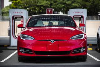 A Tesla vehicle is parked at a new Tesla Supercharger station next to the LINQ High Roller on Tuesday, July 23, 2019.