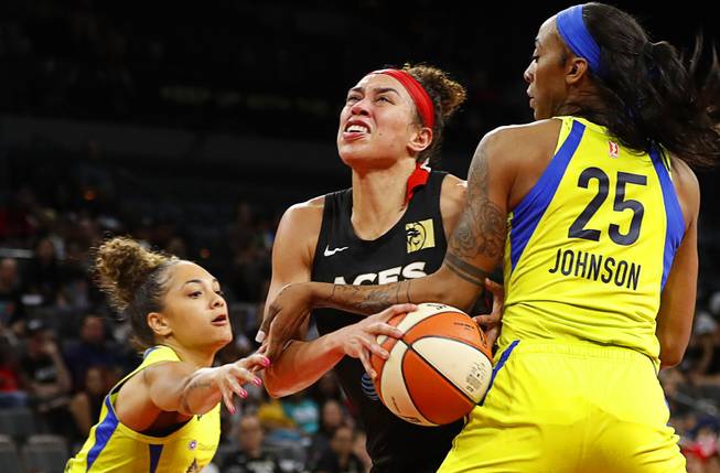 Las Vegas Aces' Dearica Hamby (5) is fouled by Dallas Wings' Glory Johnson (25) during a WNBA basketball game at the Mandalay Bay Events Center Tuesday, July 30, 2019.