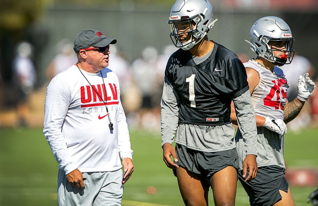 UNLV Rebels head coach Tony Sanchez talks with quarterback Armani ...