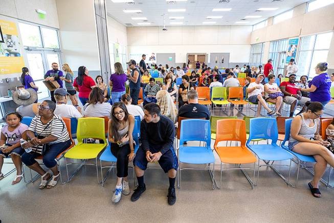 Families wait in the Englestad Adoption Building during "Clear the Shelters Day" at the Animal Foundation's GreenGale Campus, 655 Mojave Rd., Saturday, Aug. 17, 2019. Adoption fees were waived for the annual one-day event, part of a national effort to connect shelter pets with new homes.