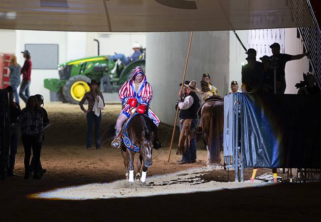 Andrea Fappani of Scottsdale, Ariz. enters the arena for a boxing-themed performance during the $50,000 Added Invitational Freestyle competition at the South Point Arena Saturday, Aug. 17, 2019. The event was part of "The Run For a Million," the world's richest reining championship event, which was filmed for Paramount Network's "The Last Cowboy."