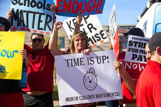 Teacher Jennie Biesinger, center, pickets with other teachers and supporters outside Liberty High School in Henderson Thursday, Aug. 22, 2019. The Clark County Education Association, the largest teachers union in Clark County, has scheduled a strike for Sept. 10 if it doesn't reach an agreement with the Clark County School District.