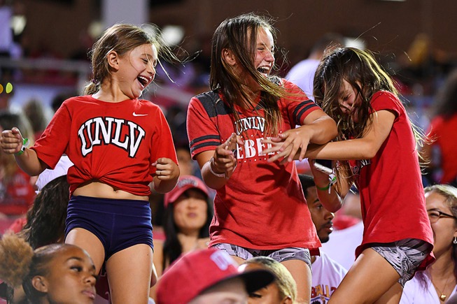 Young UNLV fans dance in the stands during their NCAA ...