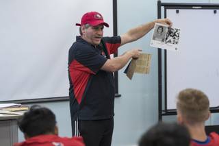 1969 Valley high state champion Jeff Eskin holds up a photo of former NFL player and Bishop Gorman graduate David Humm, as he speaks to the school's football team Wednesday, Sept. 4, 2019. WADE VANDERVORT