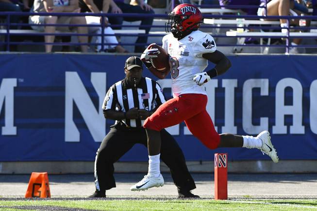 UNLV running back Charles Williams (8) runs for a touchdown against Northwestern during the first half of an NCAA college football game, Saturday, Sept. 14, 2019, in Evanston, Ill. 


