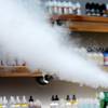 In this Tuesday, Sept. 3, 2019, file photo, a salesman at a vape shop exhales while using an e-cigarette in Maine.