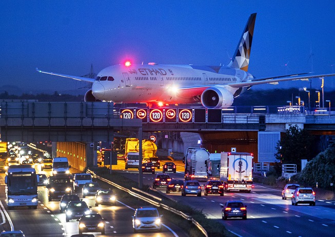 An aircraft crosses a bridge over a highway the airport ...