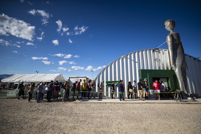 Attendees wait in line at the Alien Research Center during ...
