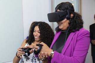 Terbine employee Ebonique Diaz assists City of Las Vegas Councilwoman Olivia Diaz with a virtual reality tour of Mexico City during a grand opening event at the International Innovation Center, Downtown, Wednesday, Sept. 25, 2019.
