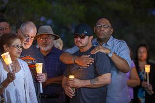 Pastor Frederick Cager gives support to James Gates, Christina Gates' husband, during a candlelight vigil to honor Christina at West Sahara Avenue and Steve Rigazio Court Thursday, Sept. 26, 2019. Gates was killed Wednesday when she was stuck by car driven by a woman suspected of being under the influence of alcohol. Crager officiated over the couple's wedding in May, he said.