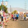 Visitors on Labor Day view candles, flowers, posters and other memorial items left in the area surrounding a Walmart in El Paso, Texas, where a shooter gunned down 22 victims on Aug. 3, 2019.
