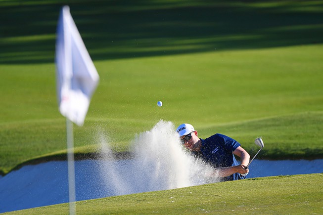 Russel Knox hits out of a sand trap on the ...